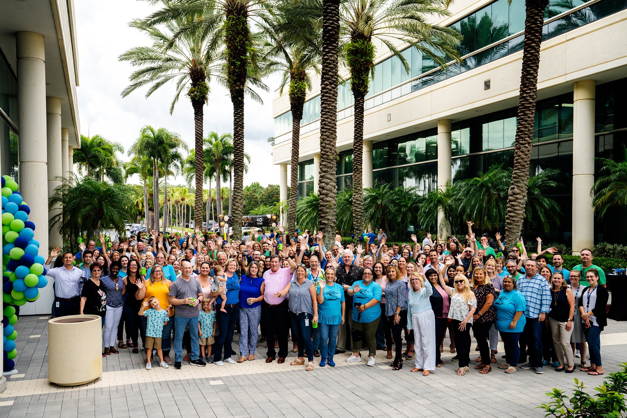 Employees across the FrankCrum enterprise gather together in celebration.